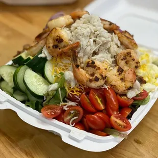 a salad in a styrofoam container