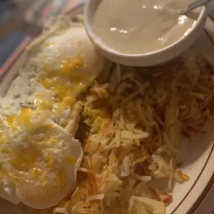 Biscuits and gravy with hash browns.
