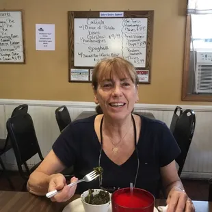 a woman eating a bowl of soup