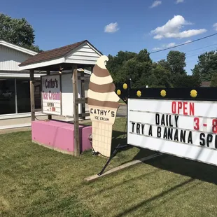 a large ice cream cone and a sign