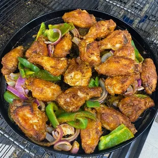 a plate of chicken and peppers