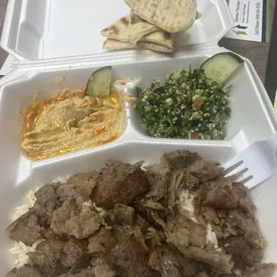 a tray of meat and vegetables