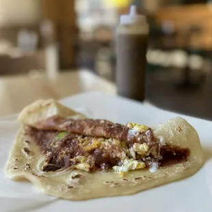 Baleada Especial w/ fried beans, cheese, scrambled egg, avocado, sour cream | $6.99 (housemade habanero + jalapeno hot sauce)