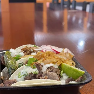 Carnitas, steak (asada), and lengua tacos