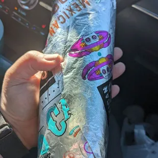 a hand holding a foil wrap