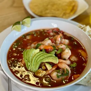 a bowl of soup and tortilla