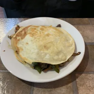 Shrimp and steak fajita quesadilla...bit strange plating. No chance of eating with other than a fork and a knife.