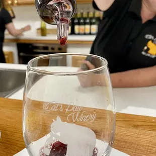 a woman pouring wine into a glass