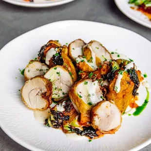 Chicken thigh roulade. a must. aloo chop (nepali style potato Pattie), longwalk kohlrabi kimchi, bok choy, smoked gouda mornay, cilantro