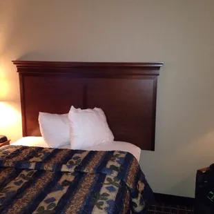 Clean bed with high thread count linens. Crown moulding adds to element.