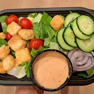 Side salad comes with tomatoes, cucumber, red onions, and croutons. Thousand Island dressing.