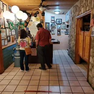 a man and a woman standing in the kitchen