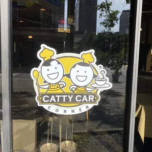 a catty car sign in a window