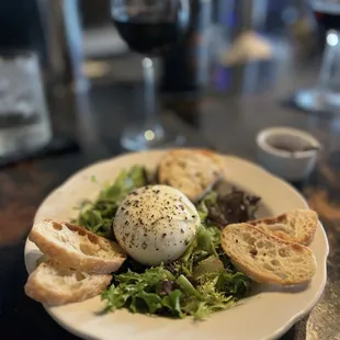 Burrata on a bed of arugula with spicy honey
