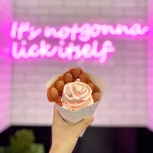 a hand holding a cupcake