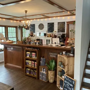 a coffee shop with a counter and stairs