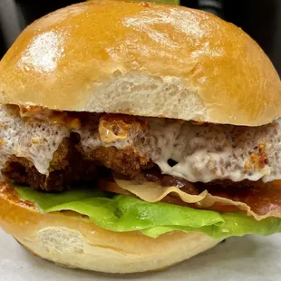 Katsu Chicken Sandwich: panko fried chicken, broiled mozzarella, crispy prosciutto, butter lettuce, tomato and spicy mayo on Dong Phuong Bun