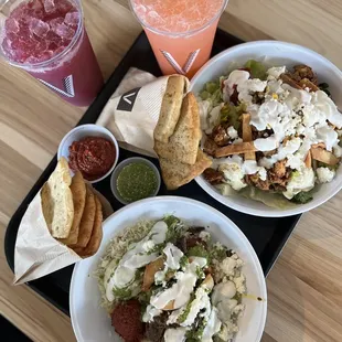 two bowls of food and a drink on a tray