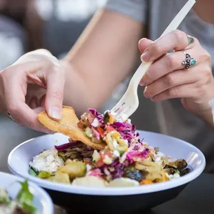 a woman eating a plate of food