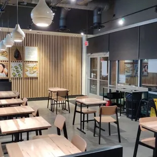the interior of a restaurant with tables and chairs