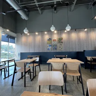 the interior of a restaurant with tables and chairs