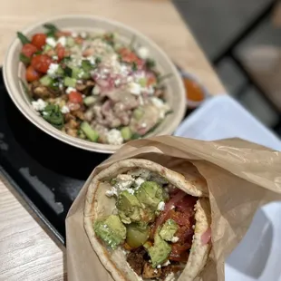 a burrito and a bowl of salad