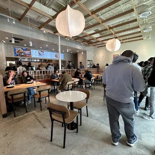 a group of people sitting at tables in a restaurant