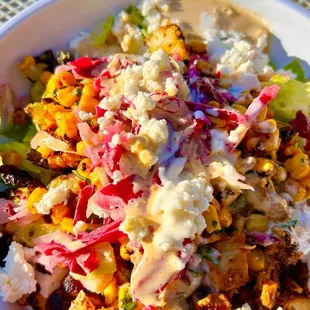 feta cheese, cabbage slaw, corn with grilled chicken and romaine, and balsamic day vinaigrette