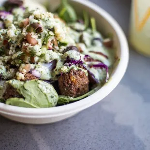 a bowl of salad and a drink