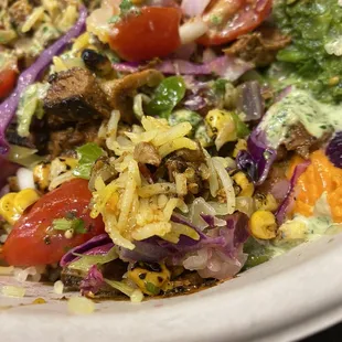 a bowl of salad with meat and vegetables