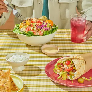 a man sitting at a table with a plate of food