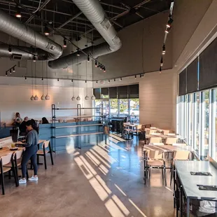the interior of a restaurant with tables and chairs