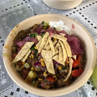 Super greens/brown rice, hummus and tazitki sauce, chicken+lamb(extra $$), pretty much all the topping besides avocado