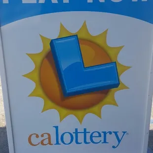 a play now sign in a parking lot