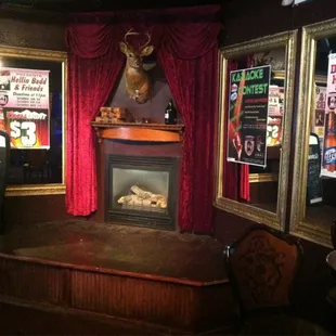 The Stage and Fireplace with the Notorious Drinking Deer