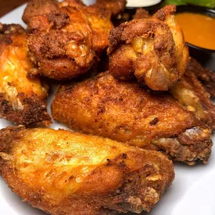 a plate of fried chicken wings