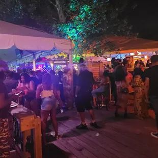 a crowd of people standing under umbrellas