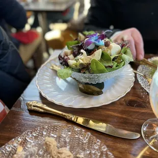 a plate of salad and a glass of wine