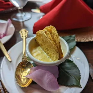 a bowl of soup and a spoon on a plate