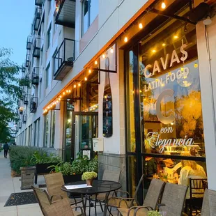 outside of a restaurant with tables and chairs