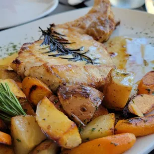 a plate of chicken and potatoes