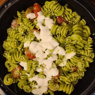 Cavatappi pasta - radiator shaped pesto pasta with cheese and cherry tomatoes