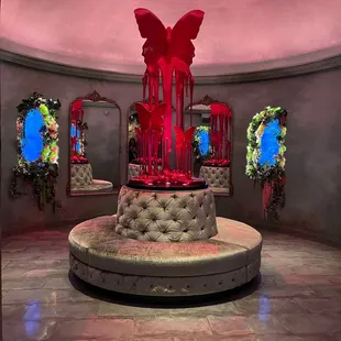 a red sculpture in the center of a room