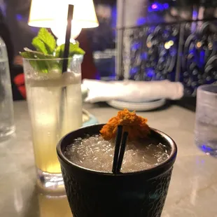 a drink in a glass with a straw and a garnish