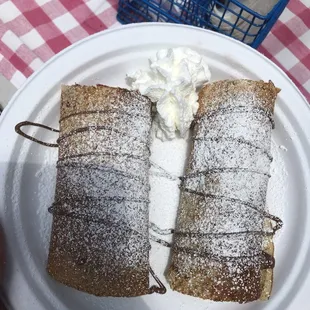 a person holding a plate of dessert