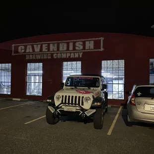 a jeep parked in front of a building
