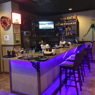 a bar with purple lighting
