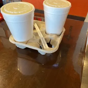 two plastic cups on a tray