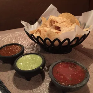 Three salsas come with the chips.  Green and red traditional and then a warmed red