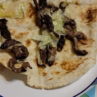 What kind of tacos is this burned steak where the onion and cilantro at and tacos sauce